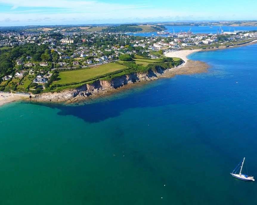 Aerial view of the Falmouth coastline — Swanpool beach and the cliffs in the foreground, Gyllyngvase, the town and the docks beyond
